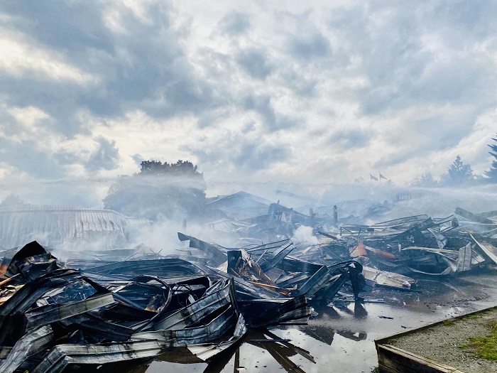 Smoke lingers above the burnt remnants of Hazel Trembath Elementary school